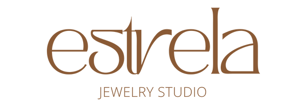 The logo for 'estrela JEWELRY STUDIO' is displayed on a solid white background. The brand name 'estrela' is written in a prominent, elegant brown serif font, with 'JEWELRY STUDIO' in a smaller, clean sans-serif font directly underneath.